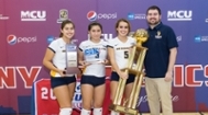 Women's Volleyball team members holding up the CUNYAC trophy