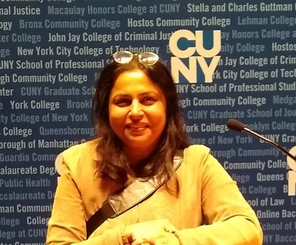 Sarbani Ghoshal smiling with CUNY backdrop