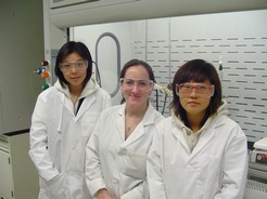 3 female students wearing white coats and goggles