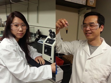 male and female students wearing lab coat and goggles in lab