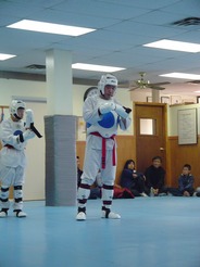 two Taekwondo fighters in protective attire