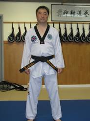 full body picture of Dr. Shin wearing Taekwondo attire