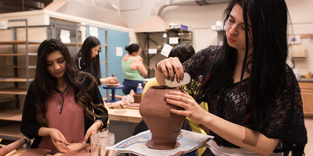 Student working with ceramics