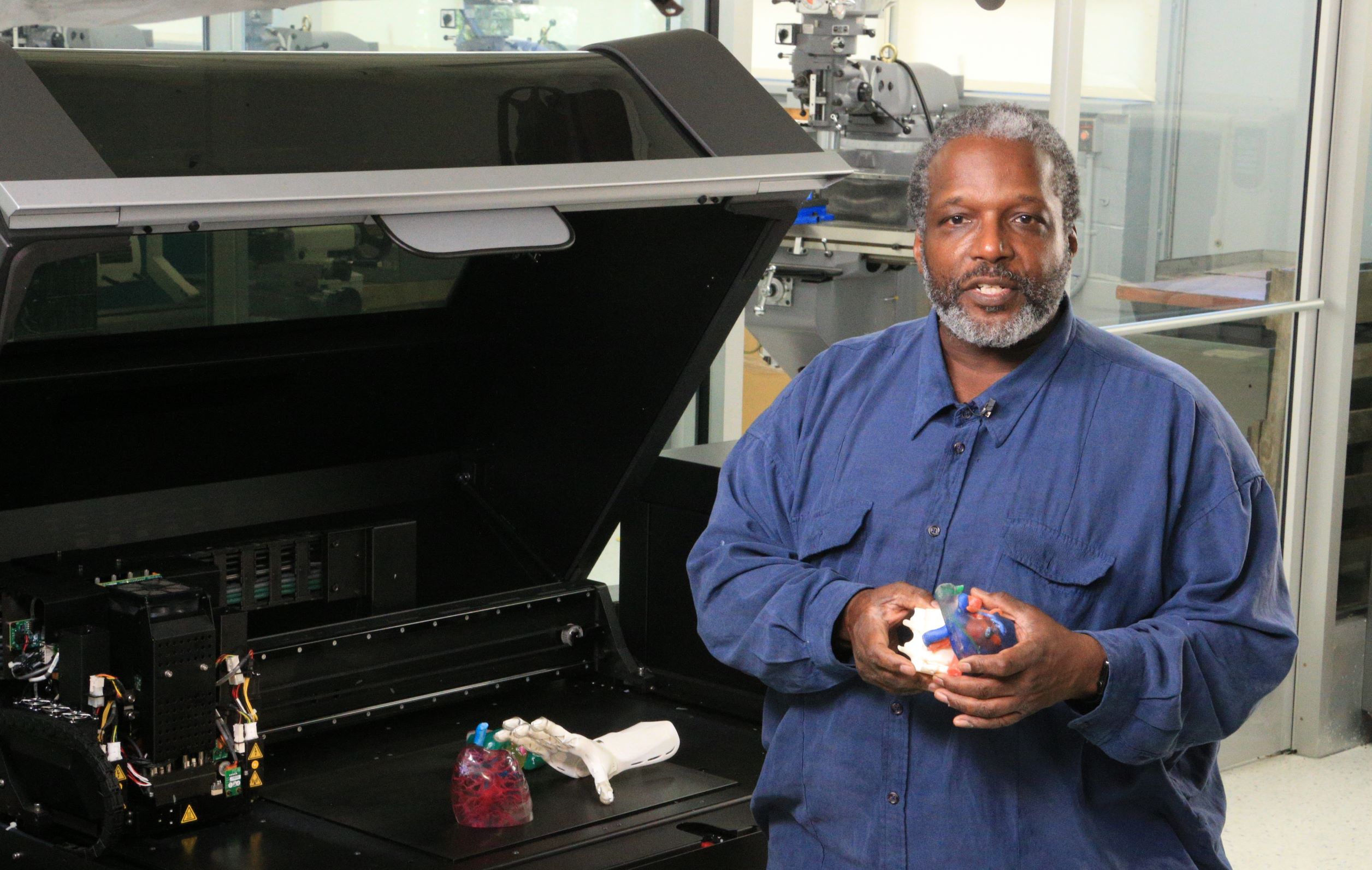 Queensborough Community College's Michael Lawrence with 3D printed medical models