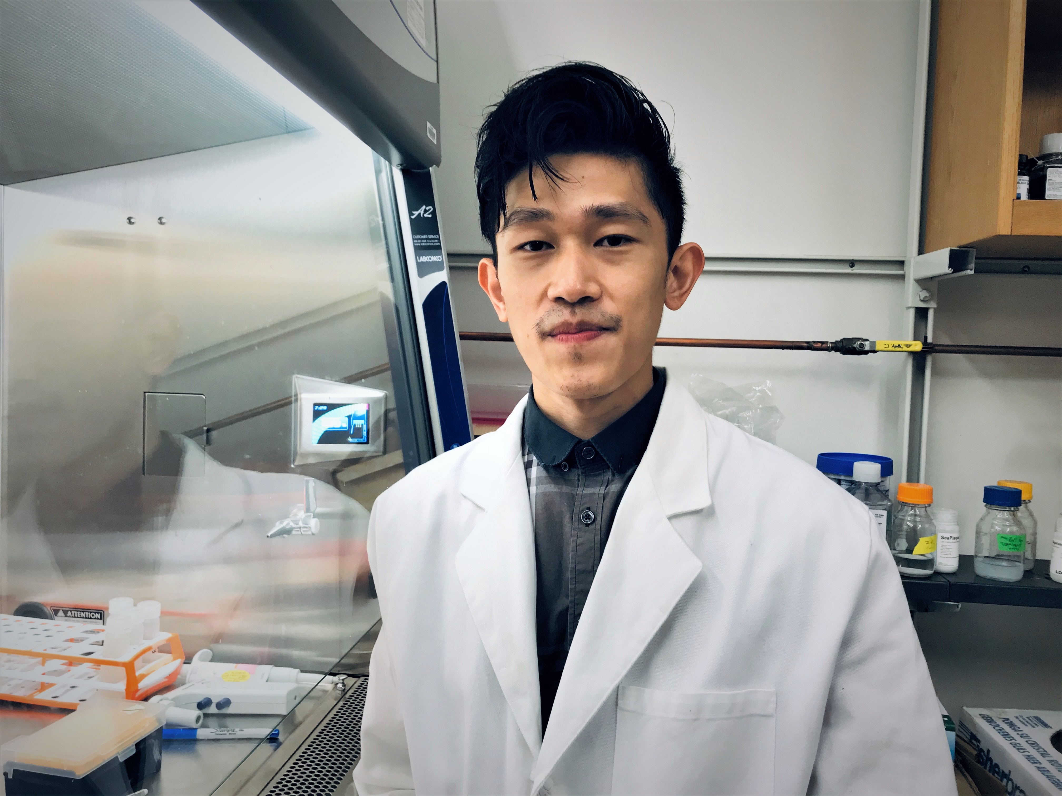 Kaung Myat San in the lab, wearing a white coat